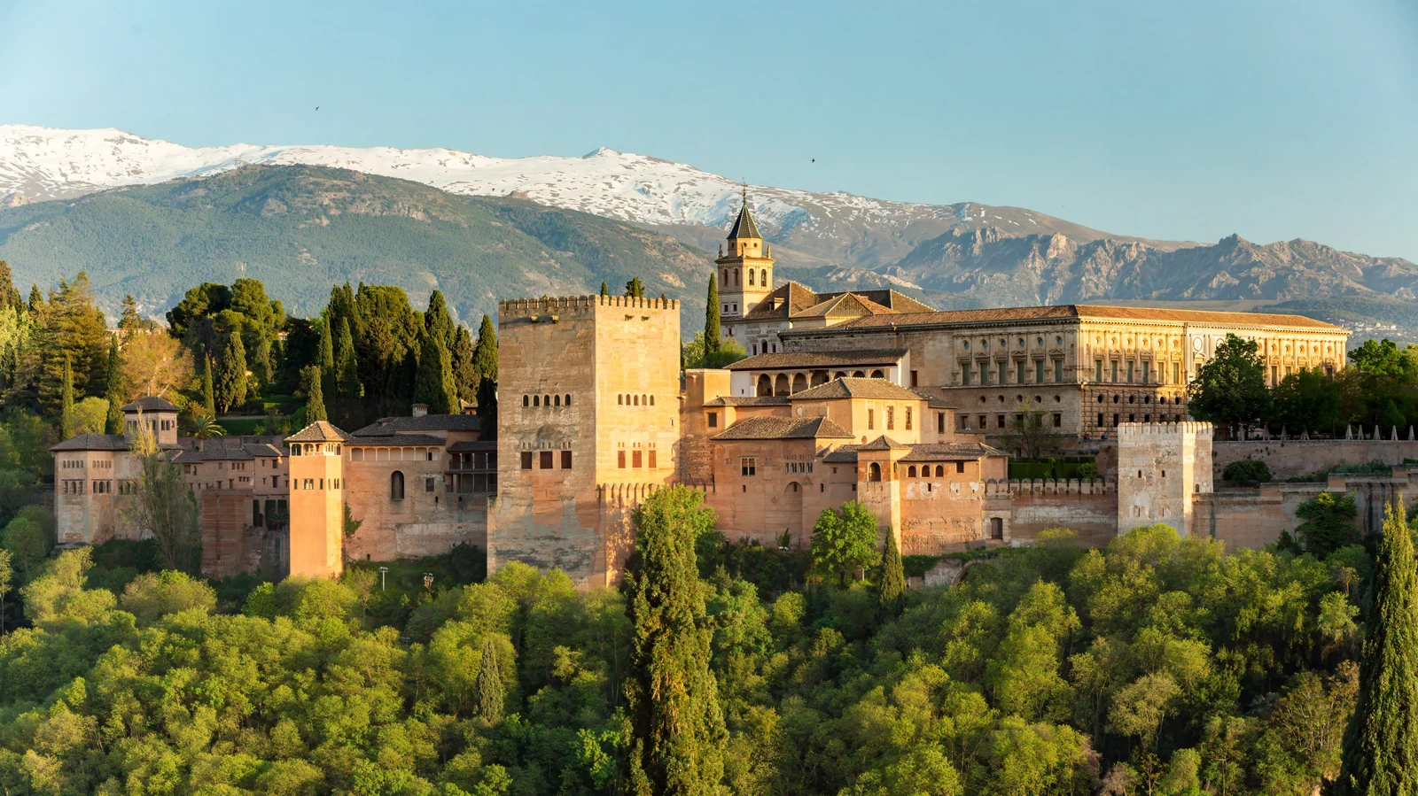 The Alhambra in evening light with the snow-covered Sierra Nevada behind it, viewed from Mirador de San Nicolás.